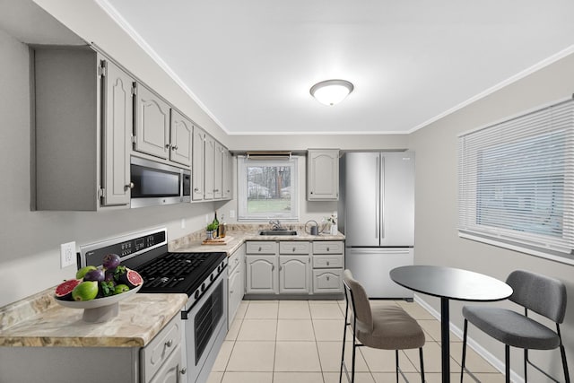 172 Nanti St, Park Forest, IL 60466 - kitchen with appliances with stainless steel finishes, a sink, gray cabinetry, and ornamental molding