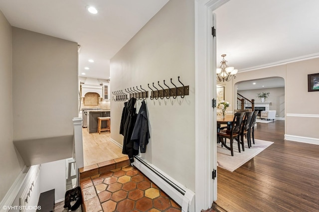 350 Elder Ln, Winnetka, IL 60093 - hall with a baseboard heating unit, arched walkways, recessed lighting, a chandelier, and dark wood-style floors