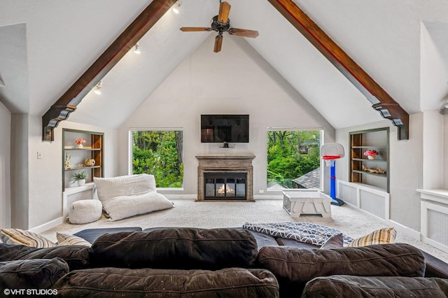 350 Elder Ln, Winnetka, IL 60093 - living room with carpet floors, built in shelves, beam ceiling, high vaulted ceiling, and a glass covered fireplace