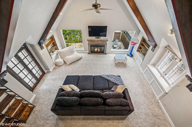 350 Elder Ln, Winnetka, IL 60093 - living area with carpet floors, high vaulted ceiling, a glass covered fireplace, a ceiling fan, and beam ceiling