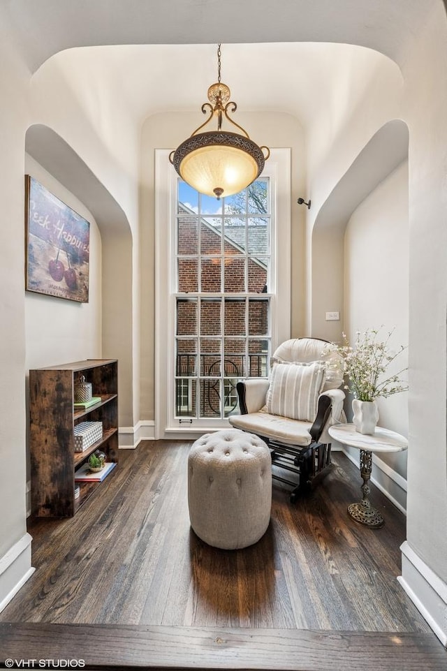 350 Elder Ln, Winnetka, IL 60093 - sitting room with arched walkways, wood finished floors, and baseboards