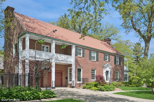 350 Elder Ln, Winnetka, IL 60093 - view of front of home with a balcony, a chimney, an attached garage, brick siding, and driveway