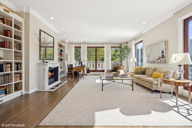 2122 N Hudson Ave, Chicago, IL 60614 - living room featuring crown molding, recessed lighting, a warm lit fireplace, wood finished floors, and built in features