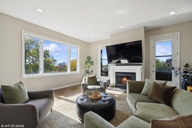 2122 N Hudson Ave, Chicago, IL 60614 - living area with wood finished floors, a lit fireplace, recessed lighting, and baseboards