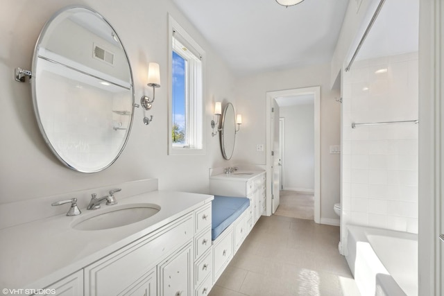 2122 N Hudson Ave, Chicago, IL 60614 - bathroom with two vanities, toilet, a shower, and baseboards