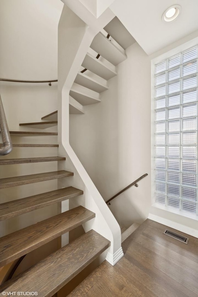 2122 N Hudson Ave, Chicago, IL 60614 - staircase featuring baseboards and wood finished floors
