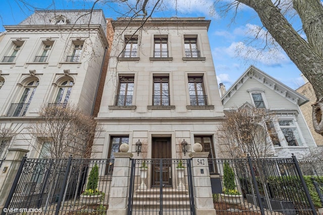 542 W Dickens St, Chicago, IL 60614 - view of front of house featuring a gate, a fenced front yard, and stone siding