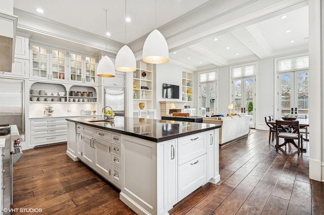 542 W Dickens St, Chicago, IL 60614 - kitchen featuring dark countertops, dark wood-style flooring, a sink, beamed ceiling, and white cabinets