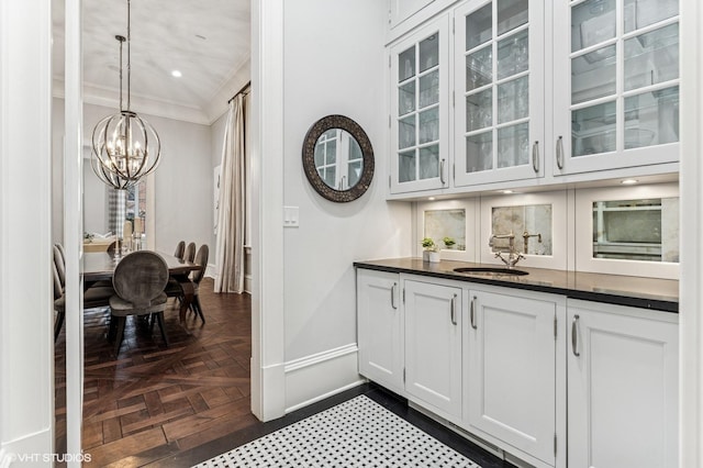 542 W Dickens St, Chicago, IL 60614 - bar with ornamental molding, a sink, a chandelier, baseboards, and hanging light fixtures