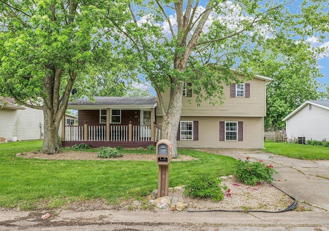 404 S Neal St, Camargo, IL 61919 - tri-level home featuring a front lawn, covered porch, and driveway