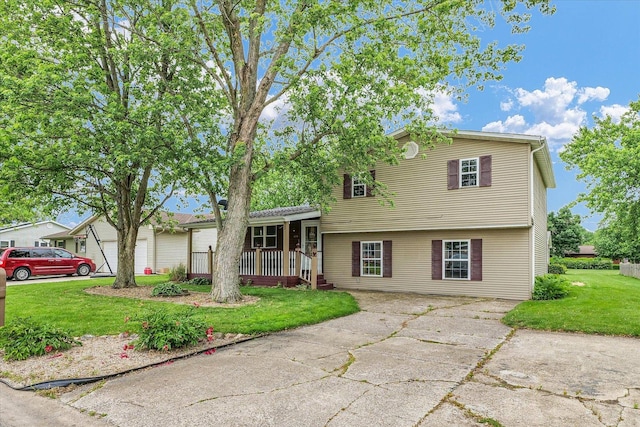 404 S Neal St, Camargo, IL 61919 - tri-level home with a front yard, concrete driveway, and covered porch