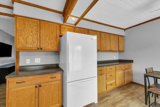 404 S Neal St, Camargo, IL 61919 - kitchen with freestanding refrigerator, dark countertops, light wood-style floors, brown cabinets, and baseboards