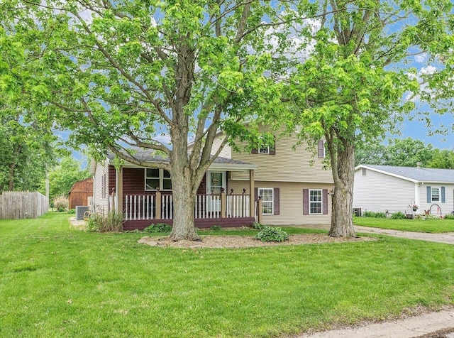 404 S Neal St, Camargo, IL 61919 - split level home with a front lawn, a porch, and central AC unit