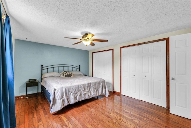 404 S Neal St, Camargo, IL 61919 - bedroom featuring multiple closets, wood finished floors, a textured ceiling, baseboards, and ceiling fan