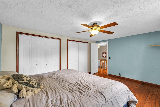 404 S Neal St, Camargo, IL 61919 - bedroom featuring multiple closets, wood finished floors, a textured ceiling, baseboards, and a ceiling fan