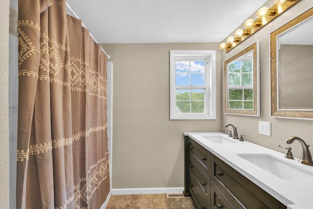 404 S Neal St, Camargo, IL 61919 - full bathroom with double vanity, baseboards, and a textured wall