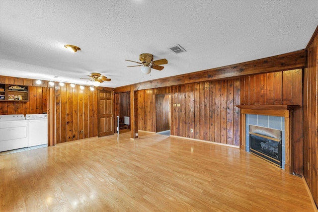 404 S Neal St, Camargo, IL 61919 - unfurnished living room with a textured ceiling, wood finished floors, a ceiling fan, wood walls, and a fireplace