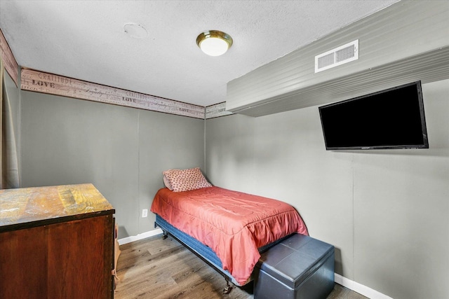 404 S Neal St, Camargo, IL 61919 - bedroom with baseboards, wood finished floors, and a textured ceiling