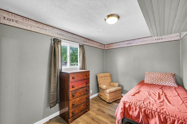 404 S Neal St, Camargo, IL 61919 - bedroom featuring light wood-style floors, baseboards, and a textured ceiling