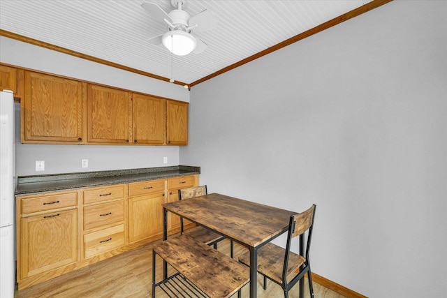 404 S Neal St, Camargo, IL 61919 - kitchen with dark countertops, ornamental molding, ceiling fan, freestanding refrigerator, and light wood finished floors