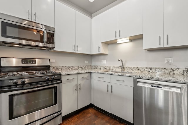 1464 S Michigan Ave Unit 810, Chicago, IL 60605 - kitchen with stainless steel appliances, dark wood-style floors, a sink, and light stone counters