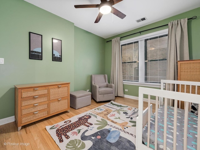 2636 N Fairfield Ave Unit 1N, Chicago, IL 60647 - bedroom featuring light wood-style flooring, baseboards, a nursery area, and ceiling fan