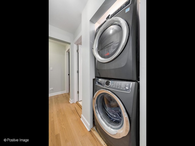2636 N Fairfield Ave Unit 1N, Chicago, IL 60647 - washroom featuring estacked washer and dryer, light wood-type flooring, and baseboards