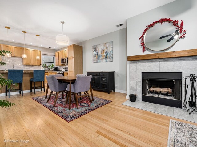 2636 N Fairfield Ave Unit 1N, Chicago, IL 60647 - dining area with light wood finished floors, baseboards, recessed lighting, and a tiled fireplace