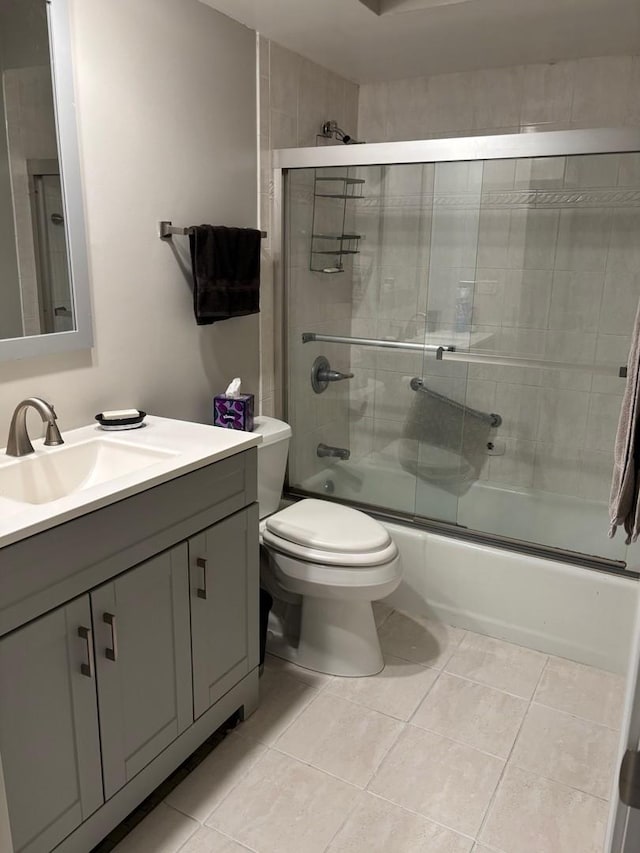 13515 Leclaire Ave Unit 55, Crestwood, IL 60418 - full bathroom featuring tile patterned floors, bath / shower combo with glass door, toilet, and vanity
