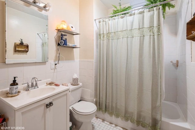 1120 W Newport Ave, Chicago, IL 60657 - full bathroom featuring toilet, shower / tub combo, vanity, a wainscoted wall, and tile walls