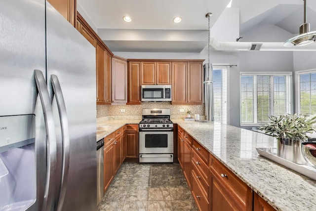1935 S State St Unit 4, Chicago, IL 60616 - kitchen featuring appliances with stainless steel finishes, healthy amount of natural light, decorative backsplash, light stone countertops, and vaulted ceiling