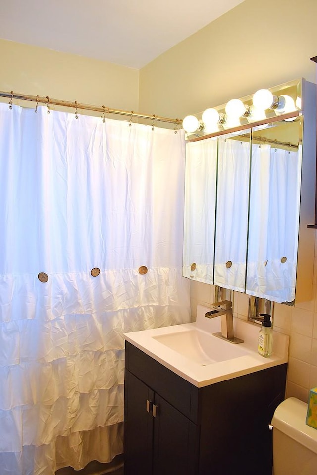 17 E Central Ave, Lombard, IL 60148 - bathroom featuring vanity, toilet, and tile walls