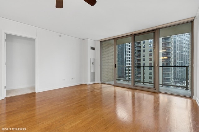 420 E Waterside Dr Unit 1103, Chicago, IL 60601 - empty room featuring healthy amount of natural light, ceiling fan, wood finished floors, a wall of windows, and baseboards