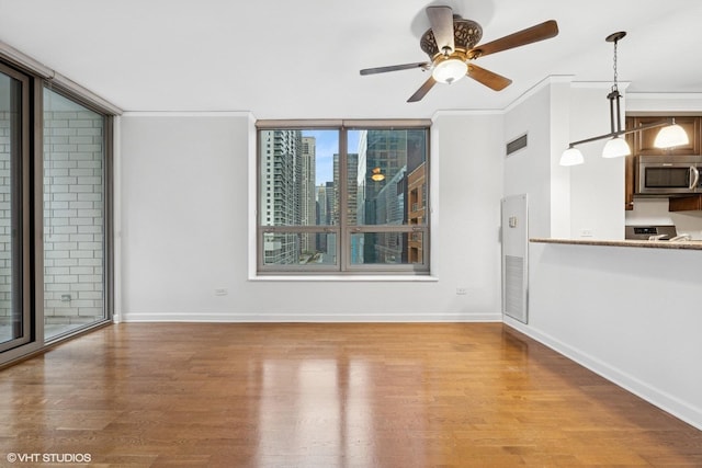 420 E Waterside Dr Unit 1103, Chicago, IL 60601 - unfurnished living room with wood finished floors, baseboards, and a ceiling fan