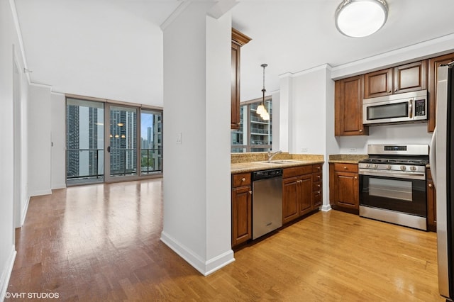 420 E Waterside Dr Unit 1103, Chicago, IL 60601 - kitchen featuring appliances with stainless steel finishes, a sink, light wood-style floors, and baseboards