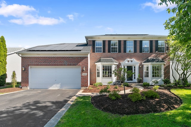 3401 Charlemaine Dr, Aurora, IL 60504 - view of front of home featuring asphalt driveway, brick siding, solar panels, and an attached garage