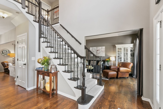 3401 Charlemaine Dr, Aurora, IL 60504 - stairs with a high ceiling, wood finished floors, baseboards, and arched walkways