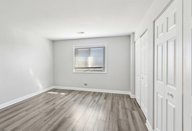 501 Mchenry Rd Unit 3B, Wheeling, IL 60090 - unfurnished bedroom with wood finished floors and baseboards