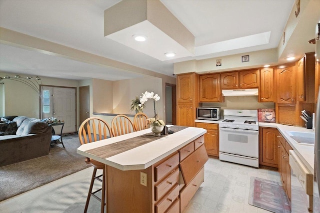 26630 W Il Route 134, Ingleside, IL 60041 - kitchen featuring white appliances, under cabinet range hood, light floors, open floor plan, and recessed lighting