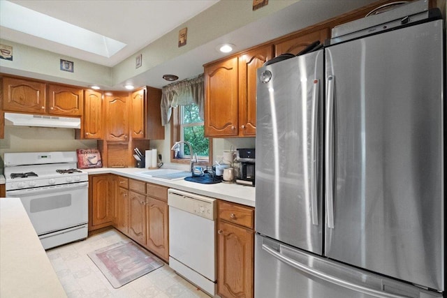 26630 W Il Route 134, Ingleside, IL 60041 - kitchen with white appliances, under cabinet range hood, a sink, light countertops, and a skylight