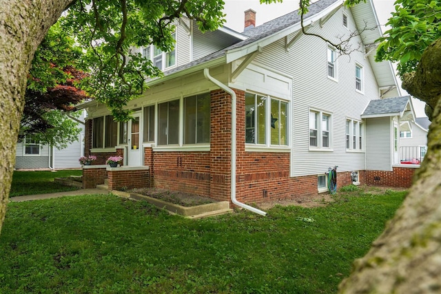 106 W Boundary St, Stanford, IL 61774 - view of home's exterior with a lawn, a chimney, and a shingled roof