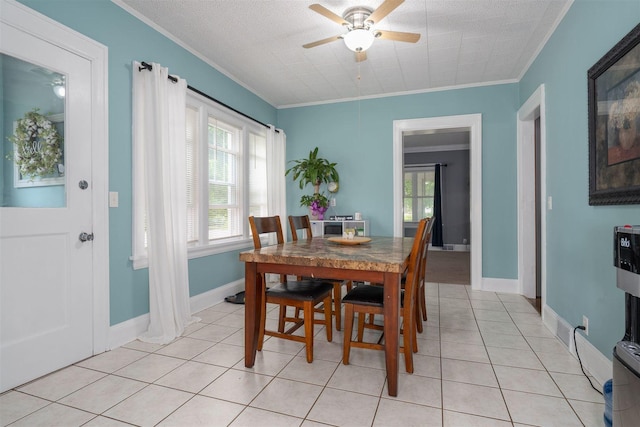 106 W Boundary St, Stanford, IL 61774 - dining space with ceiling fan, ornamental molding, plenty of natural light, light tile patterned floors, and baseboards