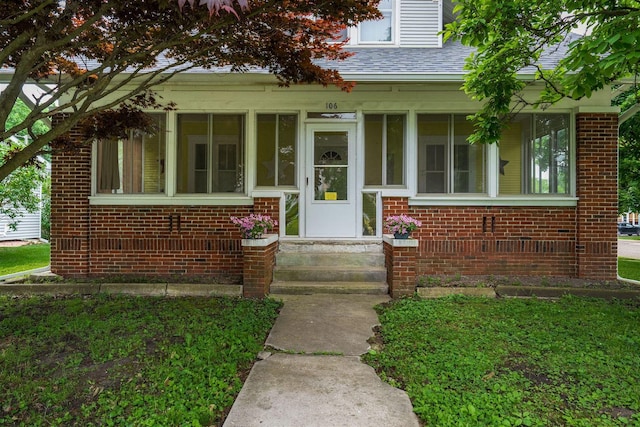 106 W Boundary St, Stanford, IL 61774 - doorway to property with a shingled roof and brick siding