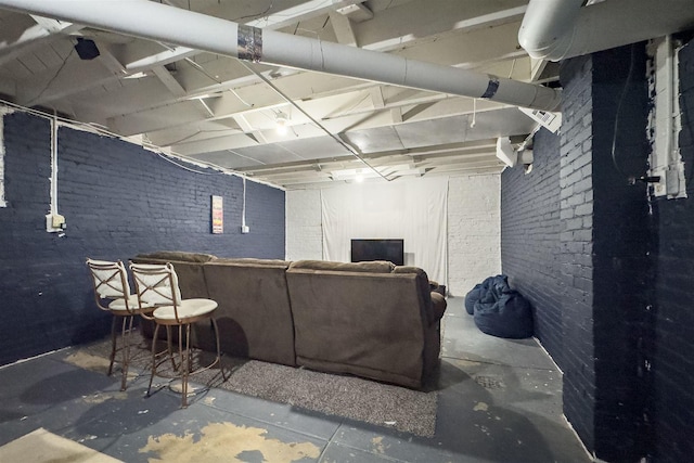 106 W Boundary St, Stanford, IL 61774 - living room featuring unfinished concrete flooring and brick wall
