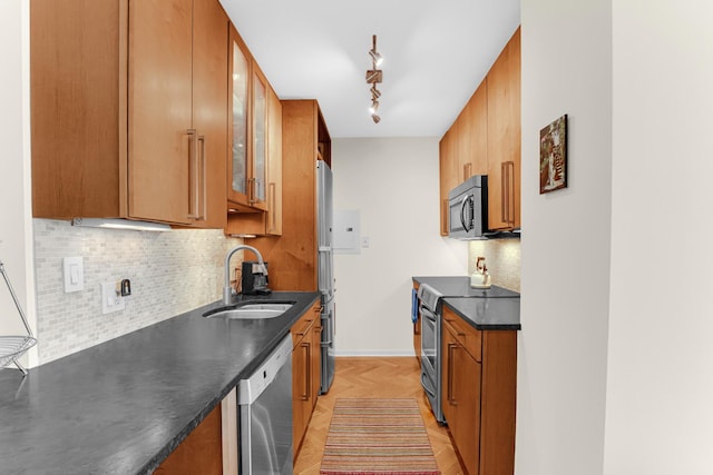 1325 N State Pkwy Unit 17C, Chicago, IL 60610 - kitchen with a sink, appliances with stainless steel finishes, dark countertops, and brown cabinets
