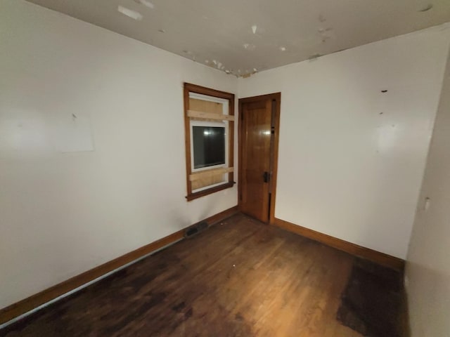 7118 S Morgan St, Chicago, IL 60621 - empty room featuring dark wood-style floors and baseboards