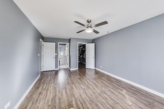 6S009 Steeple Run Dr, Naperville, IL 60540 - unfurnished bedroom featuring wood finished floors, baseboards, a spacious closet, and a closet