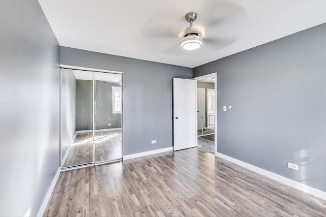 6S009 Steeple Run Dr, Naperville, IL 60540 - unfurnished bedroom featuring wood finished floors, baseboards, a closet, and a ceiling fan