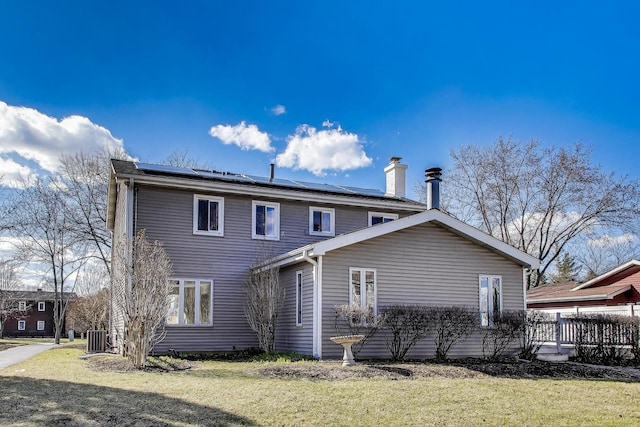 6S009 Steeple Run Dr, Naperville, IL 60540 - back of house with solar panels, a lawn, a chimney, and central AC