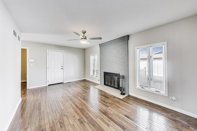 6S009 Steeple Run Dr, Naperville, IL 60540 - unfurnished living room with wood-type flooring, ceiling fan, a fireplace, and baseboards